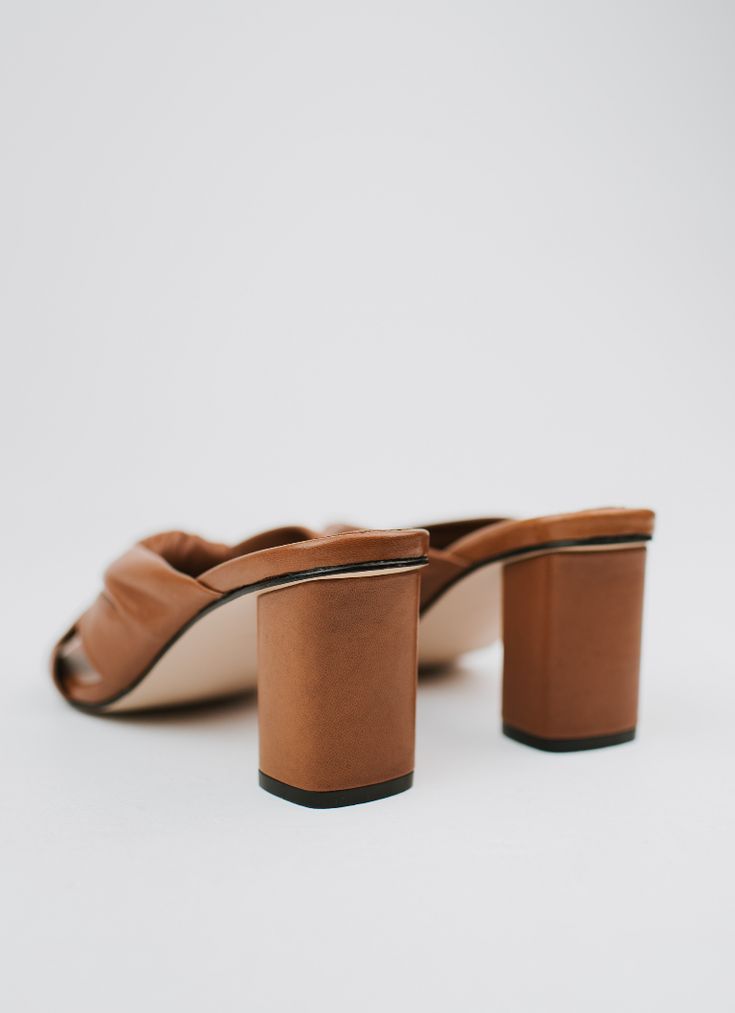 The mule version of our beloved Teresa Sandals. Crafted with meticulous attention to detail, these mules are designed to feel like you're walking on clouds. The Teresa mules have cushioned soles that provide unparalleled support and comfort for all-day wear. Featuring a beautifully crafted leather knot, these mules effortlessly elevate any outfit, adding a touch of sophistication to your look. DETAILS 100% LeatherHandmade in Mexico3.5 inch heel Elegant Brown Slip-on Slippers, Elegant Brown Slides With Leather Sole, Brown Closed Toe Mules With Sculpted Heel, Brown Mules With Sculpted Open Heel, Elegant Open Toe Clogs With Padded Heel, Brown Almond Toe Mules With Sculpted Heel, Luxury Block Heel Mules With Heel Loop, Luxury Brown Slippers With Leather Sole, Elegant Brown Mules With Padded Heel