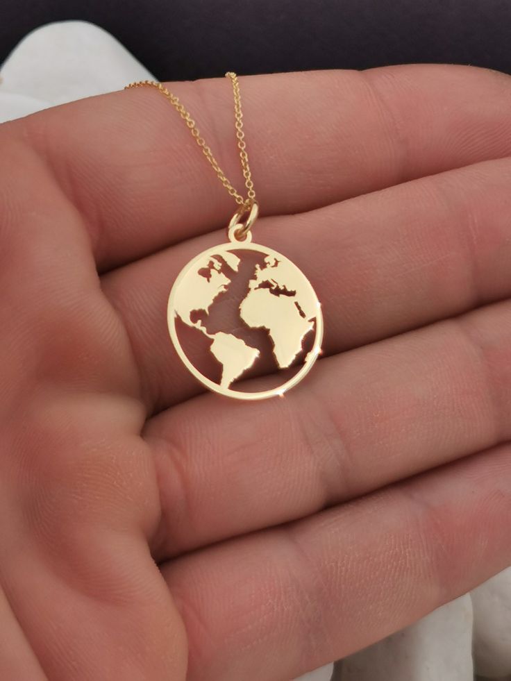 "14k Solid Gold Earth Necklace, World Map medallion Necklace, Gold Coin Globe Necklace, Gold Disc WanderLust Necklace, Globetrotter 14k Solid Gold Choose What Size You Want the Pendant Using The Second Option Box Photos Are For The 0.75 inch Diameter Pendant Pendant thickness : 0.5mm Inner diameter of jump ring : 4mm ♥ Material of pendant and chain: Solid Gold k14 ♥ Packaging: All of our jewelry are beautifully boxed and ready for gifting For more personalized designs take a look here: ♥ www.ets Gold Round Pendant Necklace For Travel, Gold Necklace With Round Pendant For Travel, Gold Engraved Jewelry For Travel, Yellow Gold Pendant Jewelry For Travel, Travel Engraved Gold Jewelry, Gold Medallion Jewelry For Travel, Earth Necklace, Wanderlust Necklace, Globe Necklace