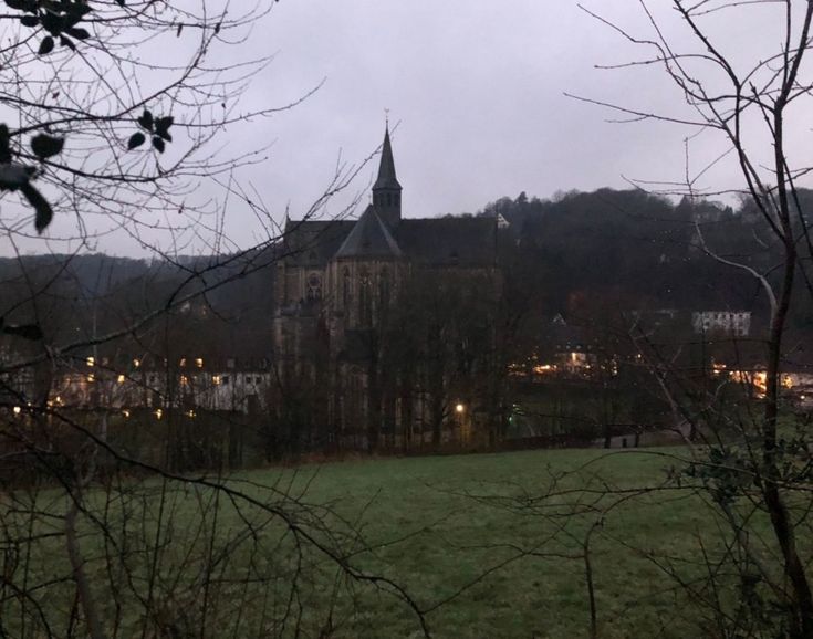 an old church lit up at night in the distance