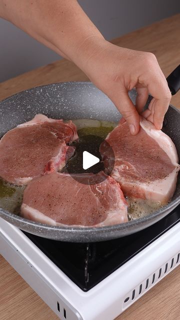 someone is cooking some meat in a pan on the stove