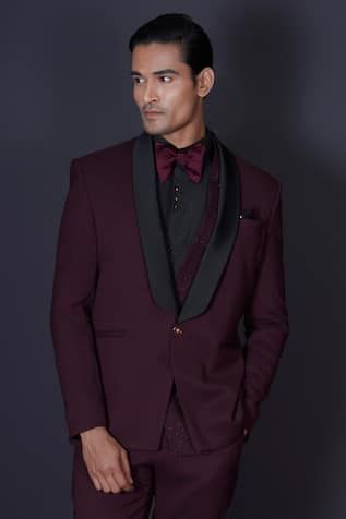 Maroon tuxedo blazer featuring kardana beads hand embroidered work behind a contrasting black lapel. Comes with a vest, black shirt, pant and a bow-tie. - Aza Fashions Tailored Party Wear Blazer For Semi-formal Occasions, Festive Evening Suits With Suit Collar, Festive Evening Suit With Suit Collar, Elegant Three-piece Suit For Semi-formal Festive Occasions, Elegant Three-piece Suit For Festive Semi-formal Occasions, Elegant Three-piece Suit For Festive Semi-formal Events, Festive Evening Tuxedo Sets, Festive Tuxedo Style Three-piece Suit, Festive Formal Tuxedo Three-piece Suit