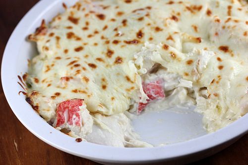 a white bowl filled with food on top of a wooden table