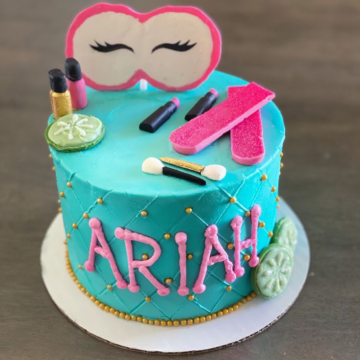 a birthday cake decorated with makeup and eyeliners for an ariah themed party