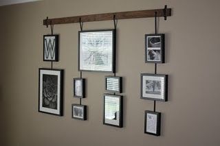 a wall with pictures hanging on it and some framed photos attached to the wall above