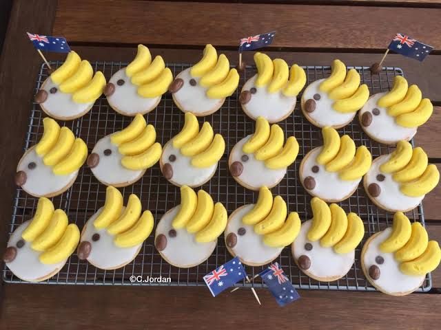 cupcakes decorated with banana slices on a cooling rack