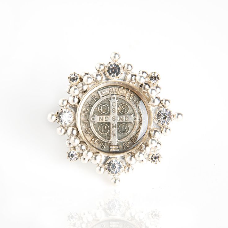 The Cloister San Benito Ring - there for peace, protection, and beauty...Always. Wear It... Sterling silver ring shank 8 Austrian crystals San Benito medallion under resin 42 hand-soldered metal balls Measures 1.75 inches circumference and weighs 27 grams & Believe! Care for with a clean dry cloth (no jewelry cleaner please). We pride ourselves on our customer service. Our secret? We believe in Angels. Handcrafted in San Miguel de Allende, Mexico. Symbol Of Peace, Saint Benedict, Ring Shank, Pearl Cream, Metal Ball, Good Fortune, Jewelry Cleaner, Faceted Crystal, Stunning Jewellery