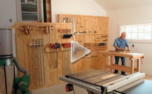 a man standing in front of a table sawing