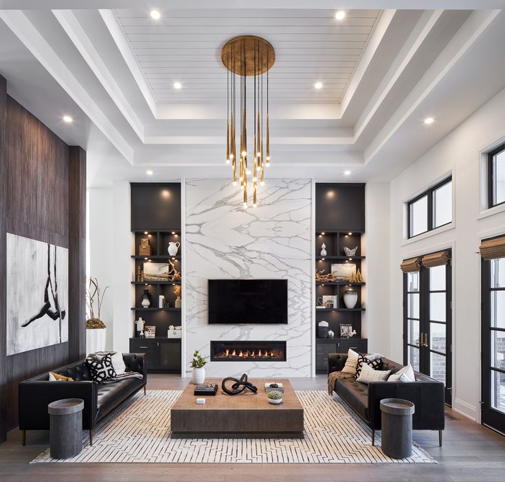 a living room with couches, chairs and a tv mounted on the wall in front of a fireplace