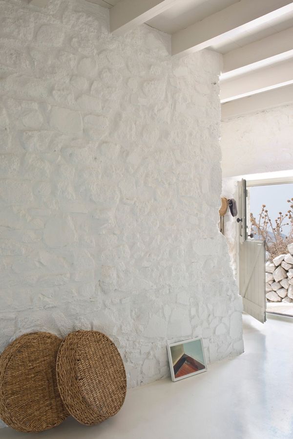 two wicker baskets sitting on top of a counter next to a white wall and door