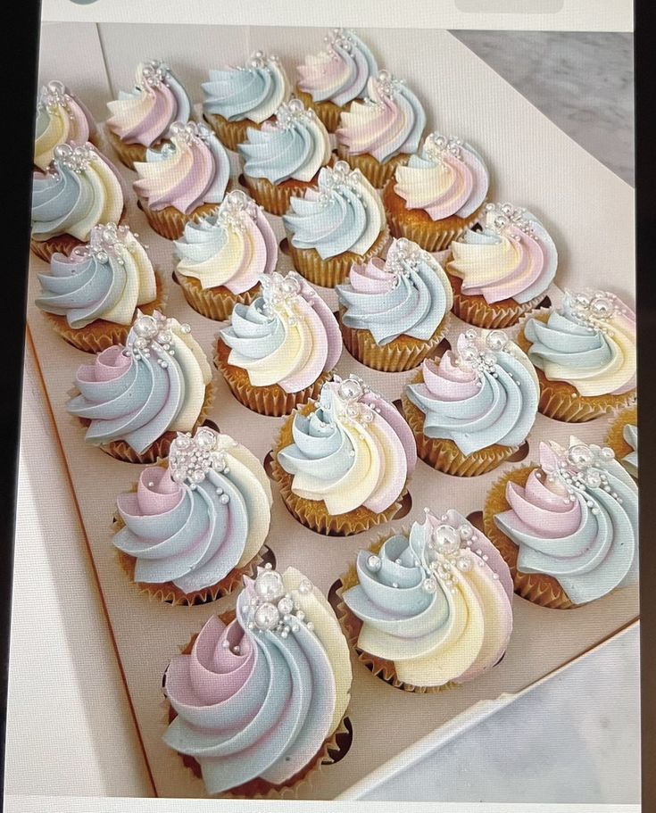 a box filled with cupcakes covered in frosting