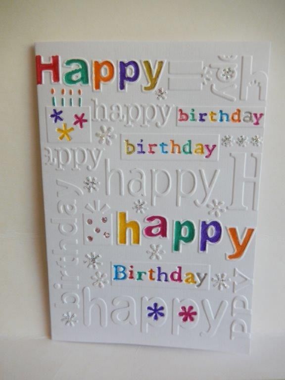 a birthday card with the words happy written in multicolored letters on white paper