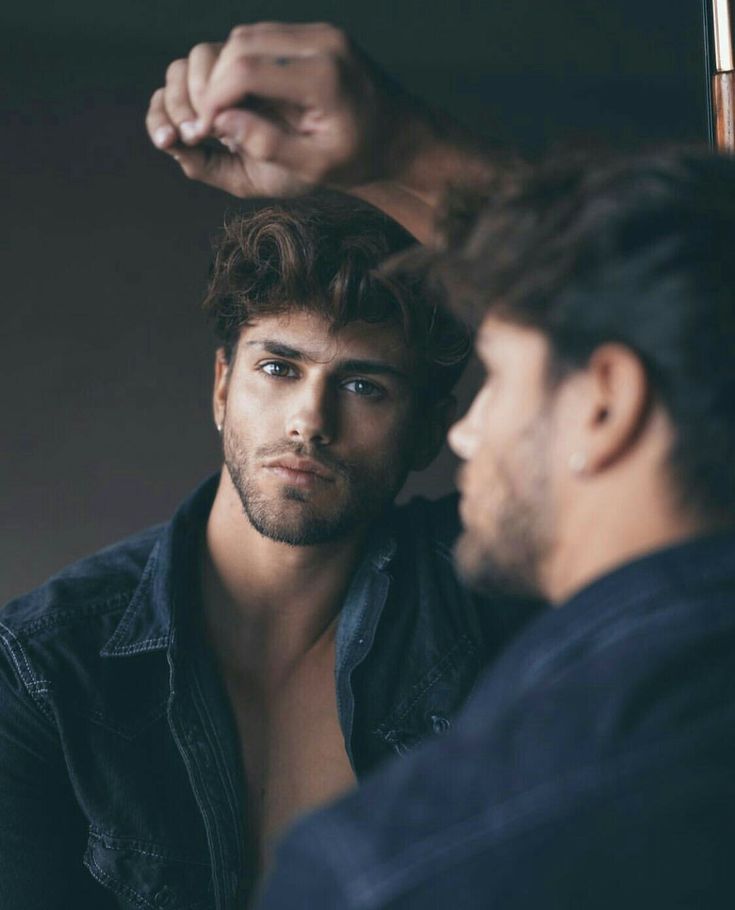 a man getting his hair styled by another man