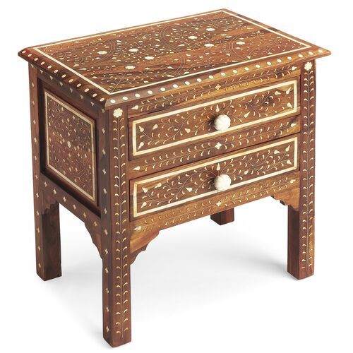 an ornate wooden table with two drawers