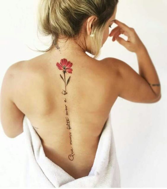 a woman with a flower tattoo on her back