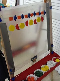 an easel with paint and paper on it