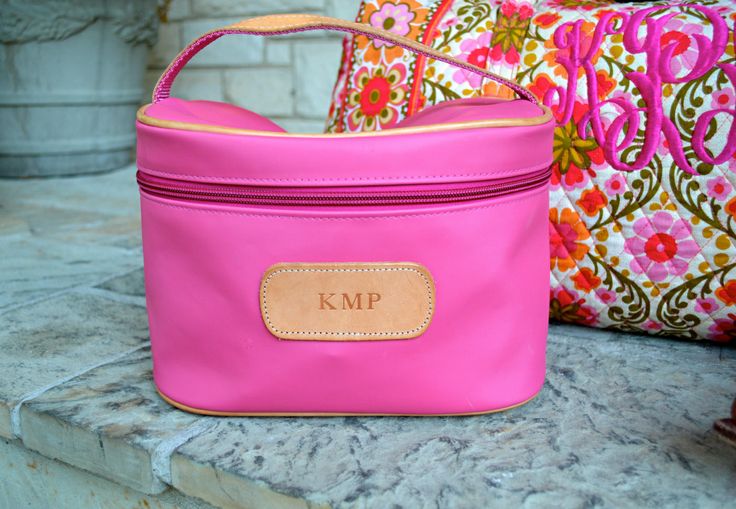 two pink purses sitting next to each other on top of a stone countertop