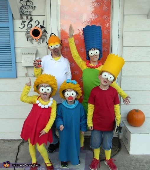 a group of people dressed in costumes standing next to each other on the front porch