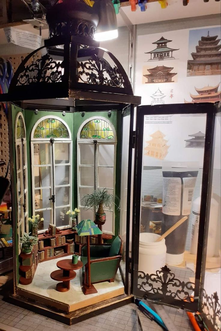 a doll house is set up in a display case