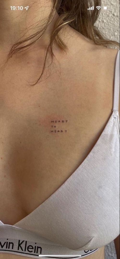 the back of a woman's shoulder with an inscription on it