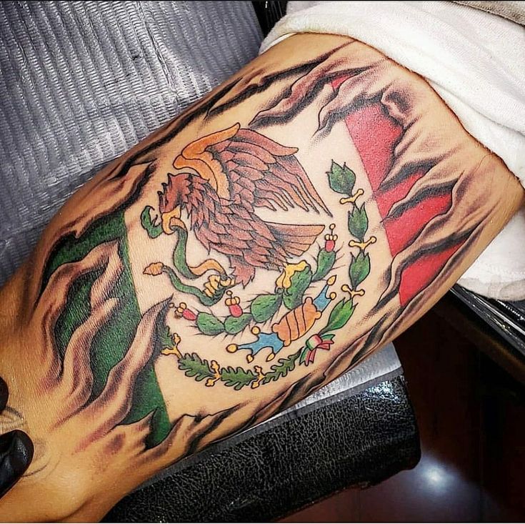 a man with a tattoo on his leg that has an eagle and the mexican flag painted on it