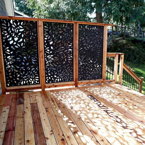 a wooden deck with laser cut screens on it