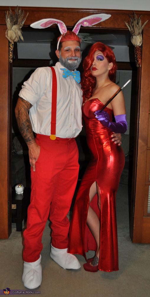 the man and woman are dressed up as bunny ears, one is wearing a red dress