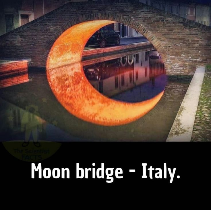 the moon bridge - italy is reflected in the water below it's reflection,