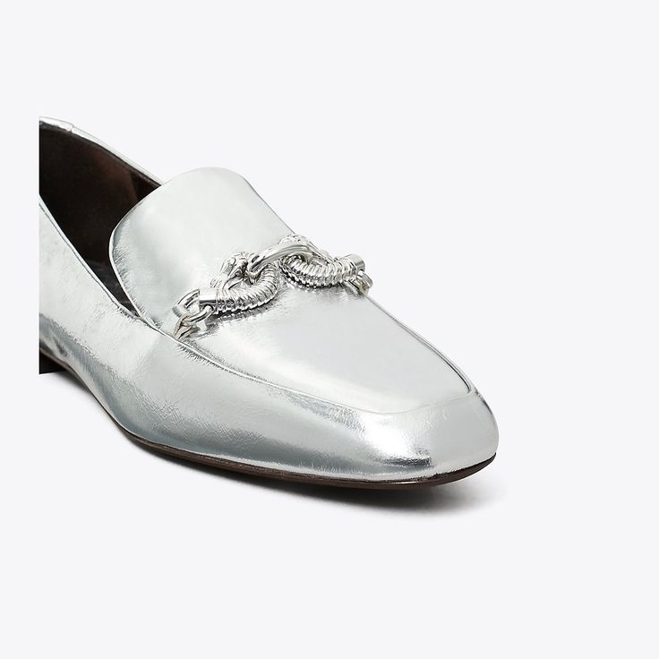 The classic loafer, distinguished by metal horsehead hardware and crafted in crinkled metallic leather. Wear it with everything from feminine dresses to menswear-inspired pieces.Crafted in partnership with a Leather Working Group-certified tannery, supporting high standards in leather manufacturing and chemical management. Silver Slip-on Business Loafers, Silver Slip-on Loafers For Business, Classic Silver Loafers For Business, Silver Loafers With Leather Sole For Business, Classic Silver Loafers For Formal Wear, Classic Silver Loafers For Formal Occasions, Luxury Silver Loafers For Business, Silver Leather Loafers For Work, Designer Silver Loafers With Leather Sole