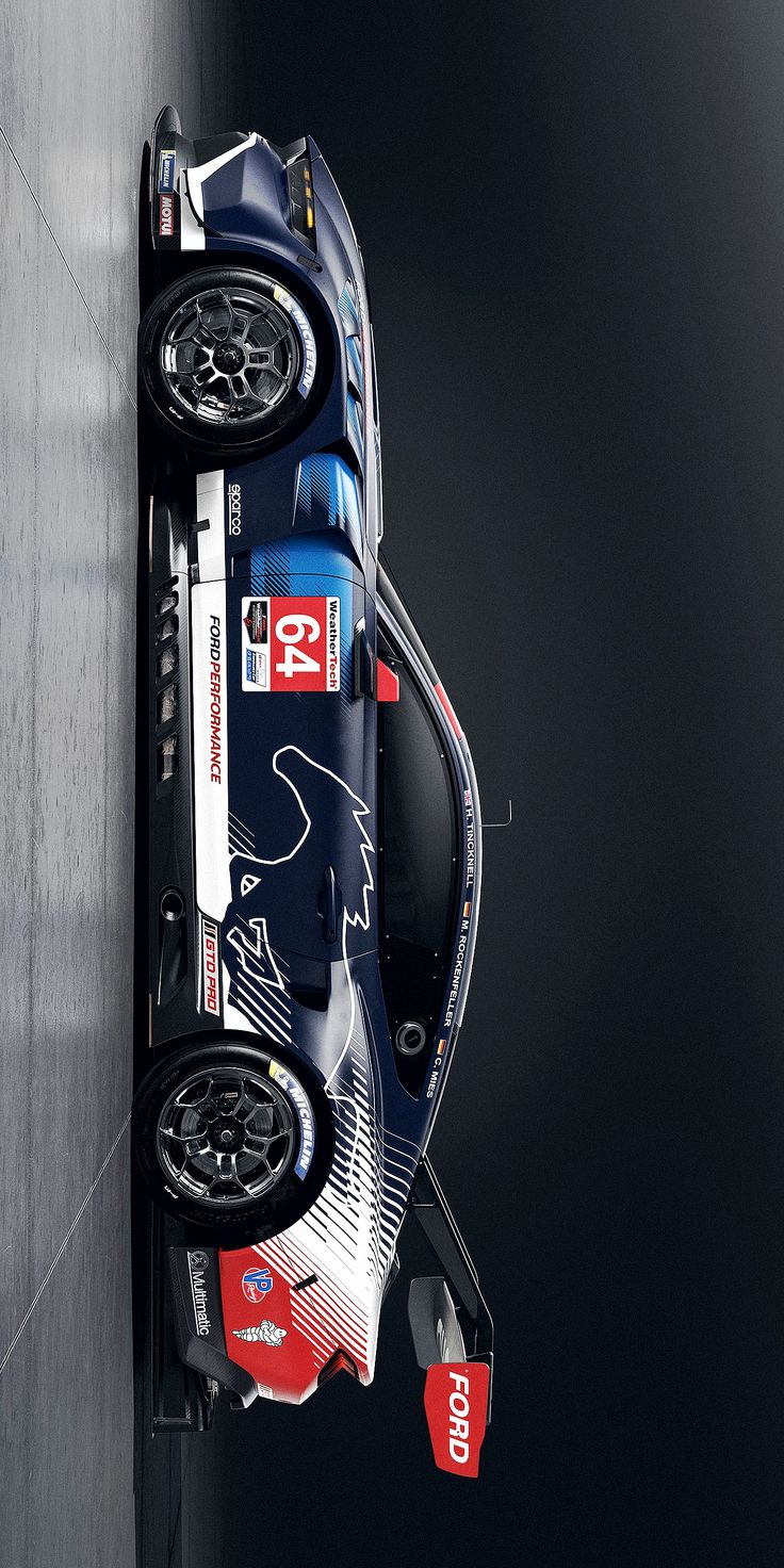 a blue race car with red and white stripes on it's side hanging off the side of a wall