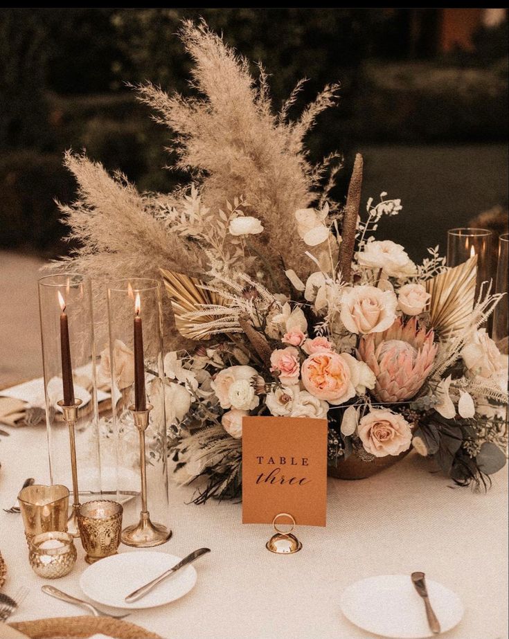 a table topped with lots of flowers and candles