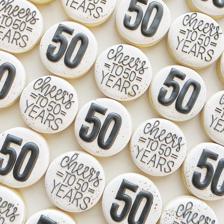 some 50th birthday cookies with the number 50 on them and fifty years printed on them