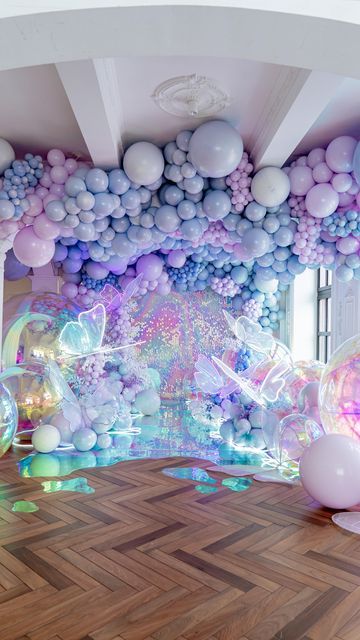 a room filled with balloons and other decorations