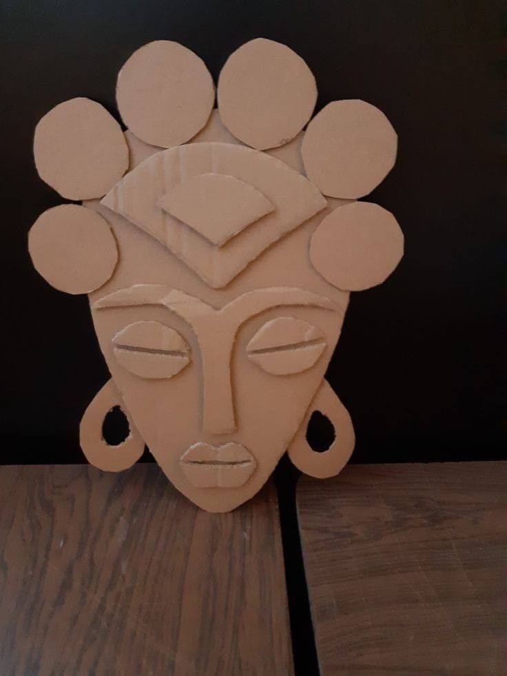 a sculpture made out of cardboard on top of a wooden table