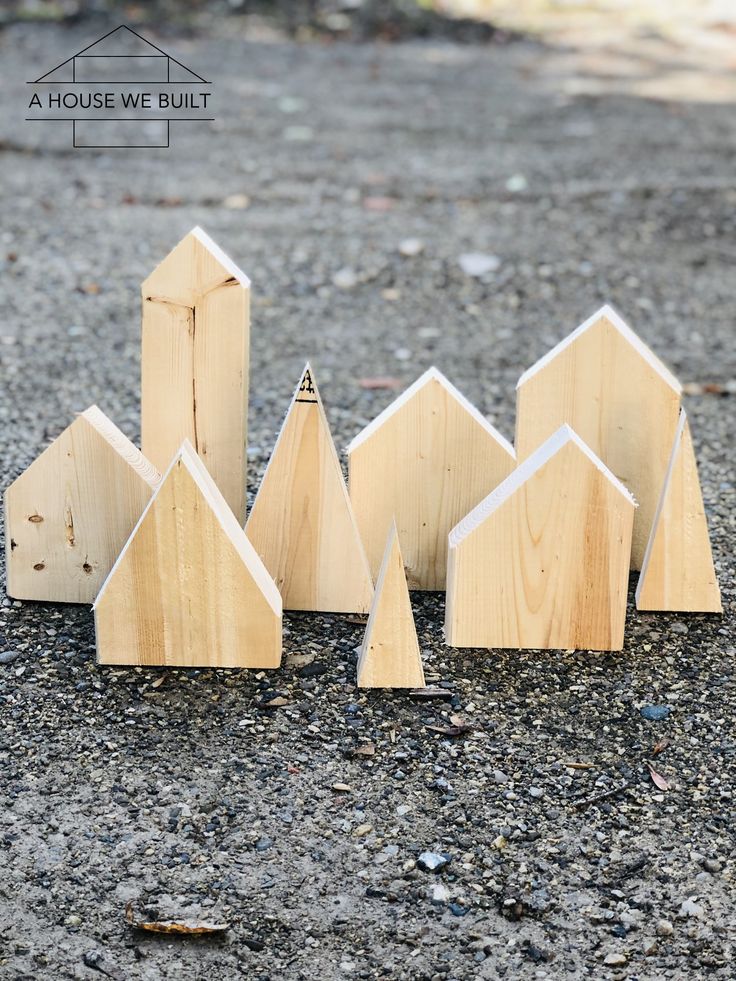 several wooden houses are lined up on the ground