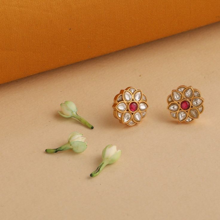 Description This pair of gold-plated silver stud earrings are designed to portray a flower bud with a delightful pink semi-precious stone. Delicate and pretty, these stud earrings are ideal companions for day-long endeavors with friends or colleagues. This product ships in 3 weeks. Product Information Metal: 925 Silver with 1.0 microns Gold Plating Length: 1.5 cm Stones: Semi-precious stones Findings: Push back closure Gemstone Earrings In Flower Shape For Gifts, Wedding Earrings With Gemstone In Flower Shape, Gemstone Flower Earrings, Flower Shaped Gemstone Earrings For Wedding, Flower Shaped Gemstone Earrings For Gifts, Gold Gemstone Flower Earrings For Wedding, Traditional Rose Gold Earrings For Gift, Traditional Pink Flower Earrings, Flower-shaped Gemstone Earrings For Weddings