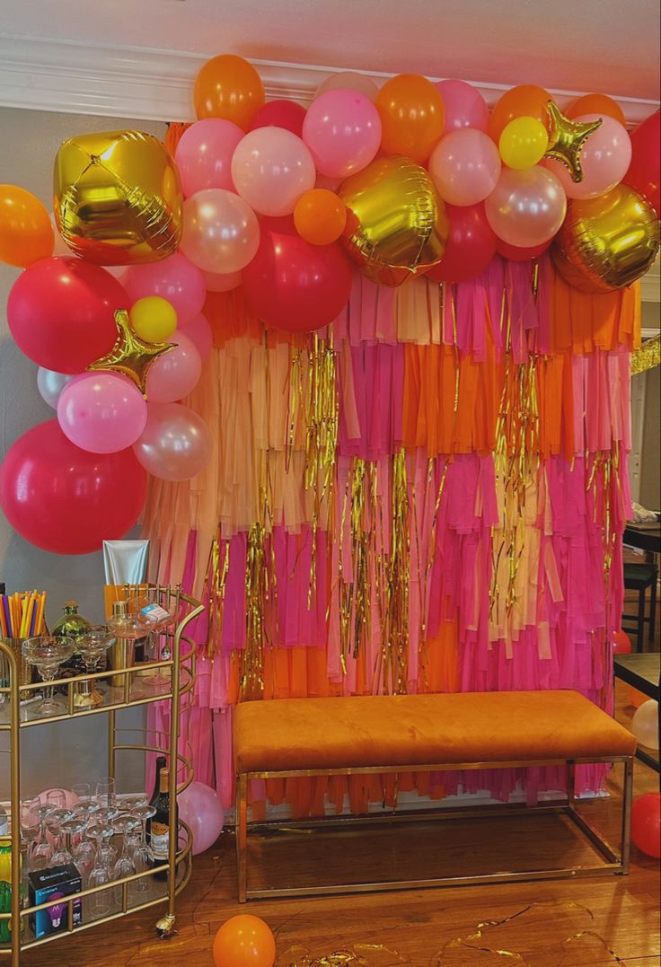 a room filled with balloons and streamers on the wall