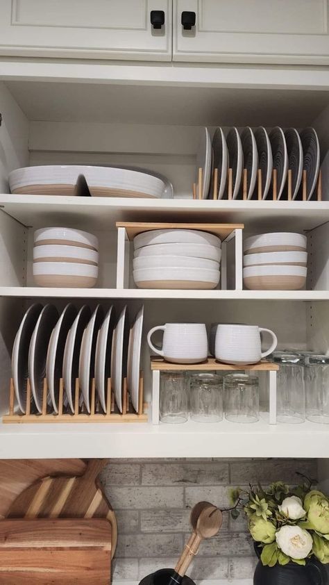 dishes and utensils sit on shelves in a kitchen