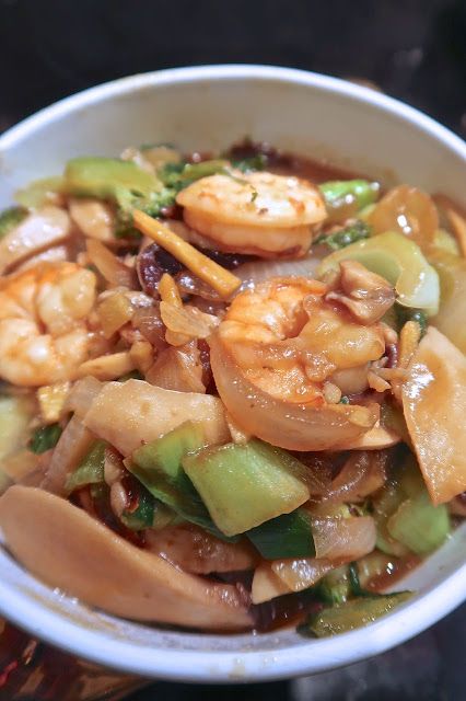 a white bowl filled with shrimp and vegetables