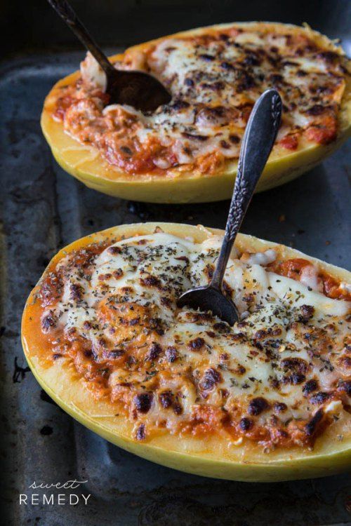 two pizzas sitting on top of a pan covered in cheese and toppings with a spatula