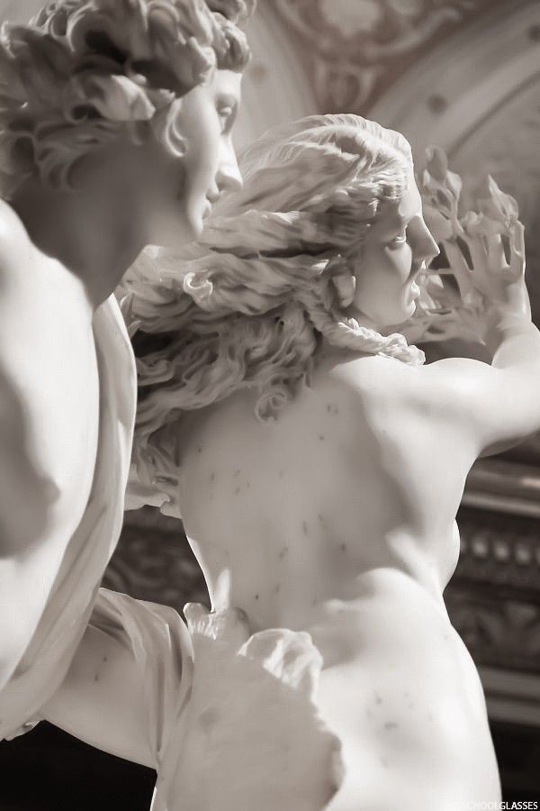 a statue of a woman with her hair blowing in the wind