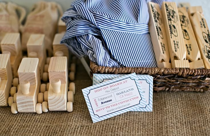 wooden toy train set sitting on top of a table next to a wicker basket