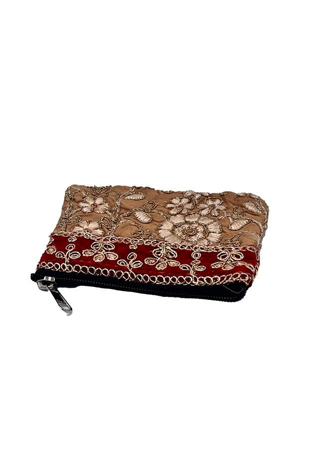 Elevate your accessory collection with this exquisite coin pouch, showcasing the intricate art of Zari embroidery. This handmade pouch features a striking combination of multiple colors and gold threads, meticulously woven into floral and paisley patterns. Perfect for the modern bohemian chic, this Banjara small pouch offers both style and functionality. Ideal for carrying coins and small essentials, it adds a touch of traditional elegance to your everyday look. Keywords: bohemian chic accessori Gold Bohemian Embroidered Clutch, Gold Bohemian Clutch For Festive Occasions, Bohemian Rectangular Cosmetic Bag Gift, Bohemian Handmade Gold Clutch, Bohemian Gold Festive Pouch, Festive Gold Bohemian Pouch, Handmade Bohemian Gold Clutch, Bohemian Gold Rectangular Potli Bag, Festive Bohemian Gold Pouch