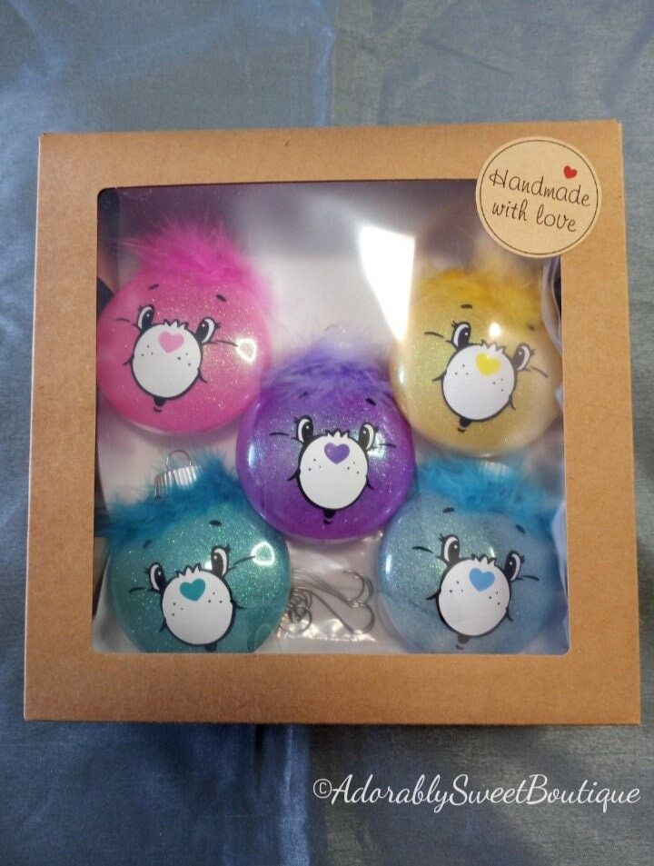 four different colored balls in a box with an image of angry birds painted on them