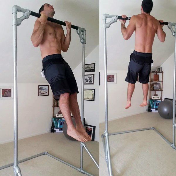 a man is doing pull ups in the mirror