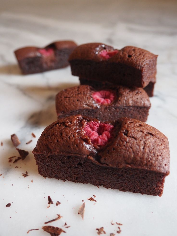 some brownies with raspberries are on a table