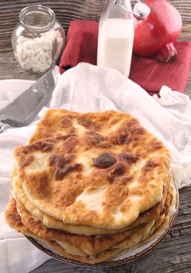 a stack of pancakes sitting on top of a wooden table