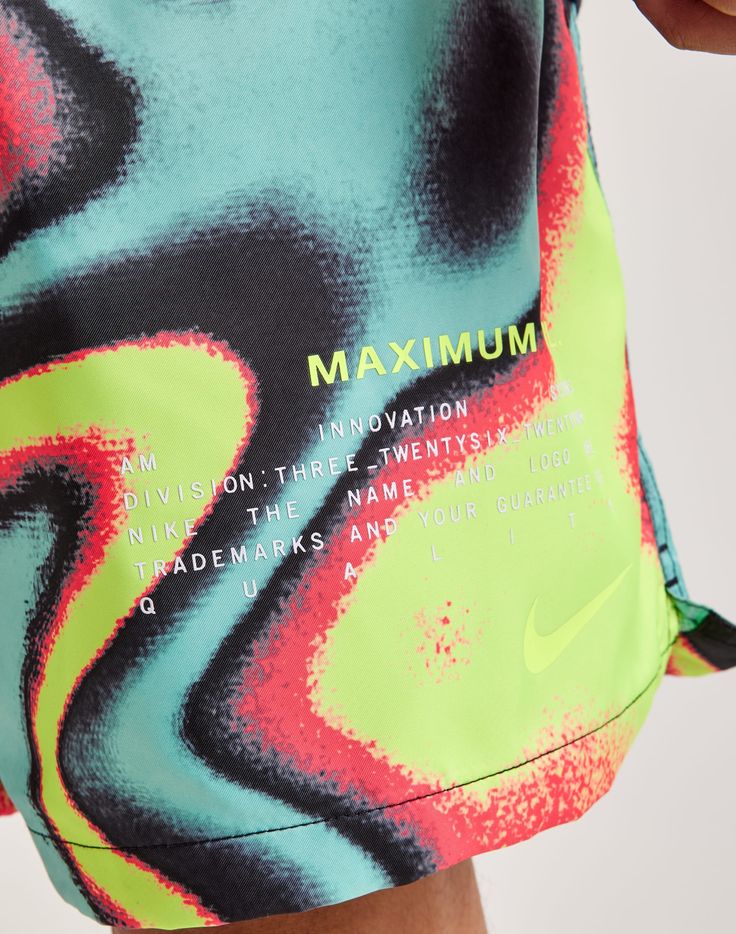 the nike swimsuit is designed to look like an abstract painting, and features neon colors