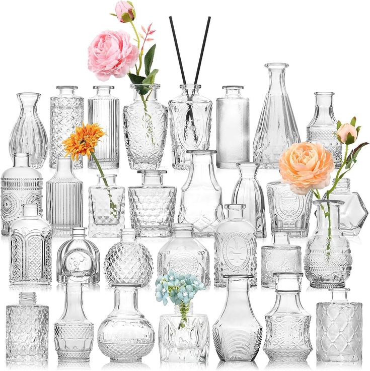 many different vases and flowers are arranged on a white background with one pink flower in the middle