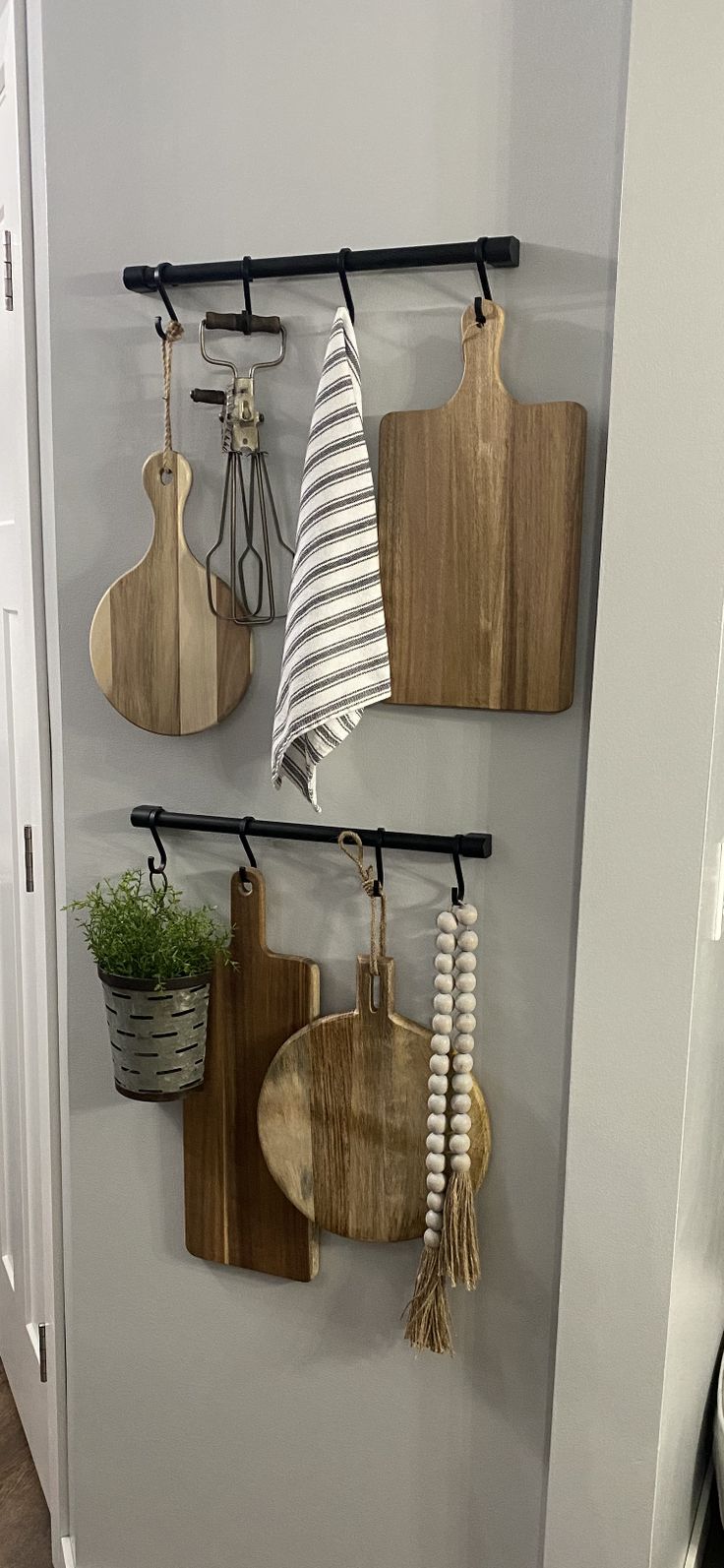 several wooden cutting boards hanging on a wall