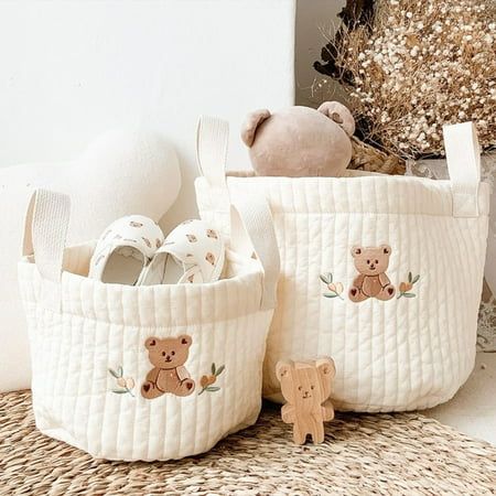 two white baskets with teddy bears on them